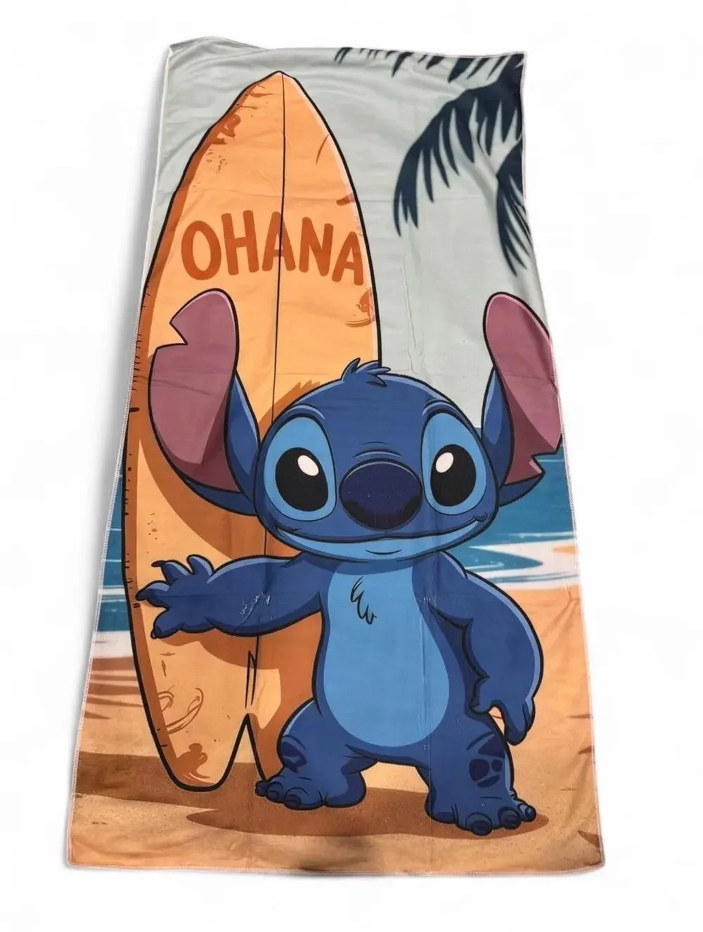 Stitch beach towel with Stitch holding a surfboard with the word 'OHANA'